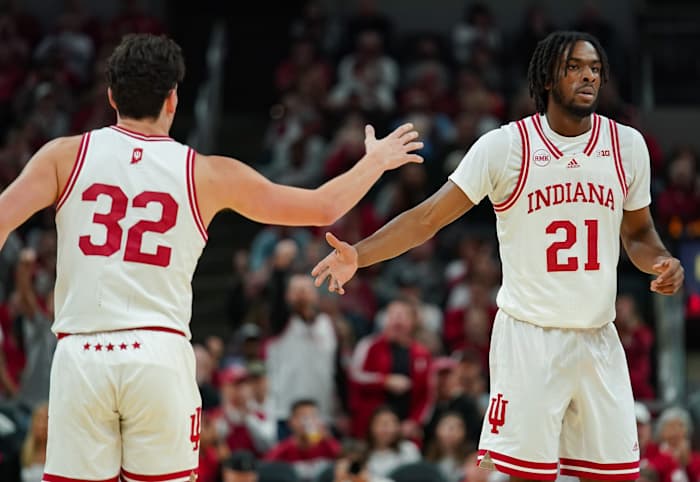Indiana Hoosiers guard Trey Galloway (32) high-fives Indiana Hoosiers forward Mackenzie Mgbako (21) during the game against Harvard.